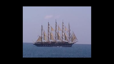 Film still from 'A Fool's Journey' (2026) by Jon Beaton. A tall ship on blue seas.